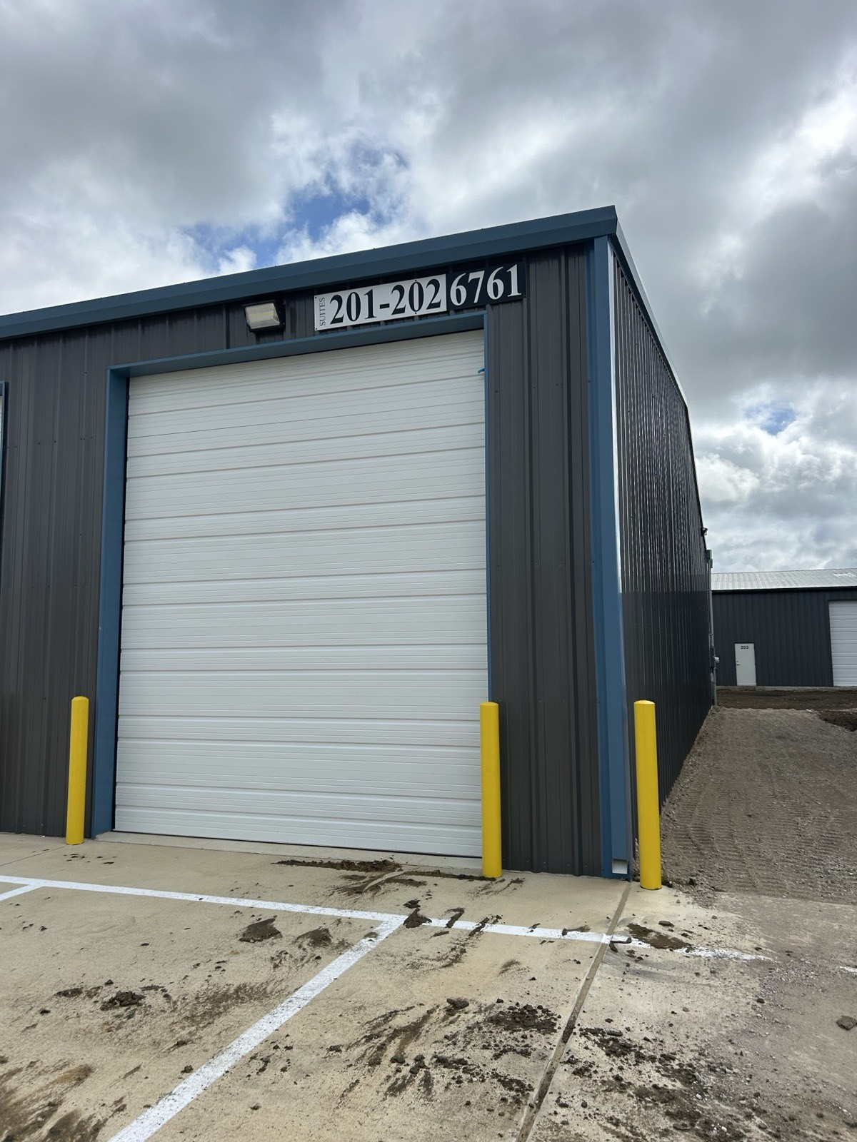 Finished commercial steel building unit with a roll-up door in North Texas